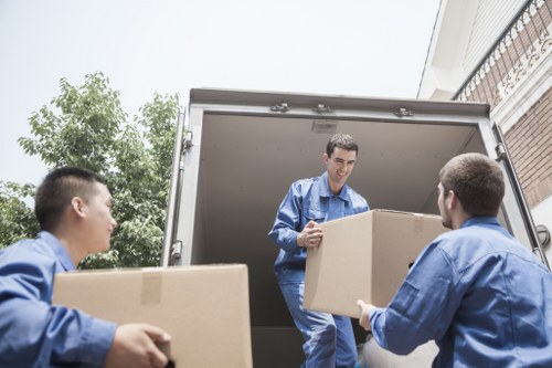 Professional movers carefully packing household items